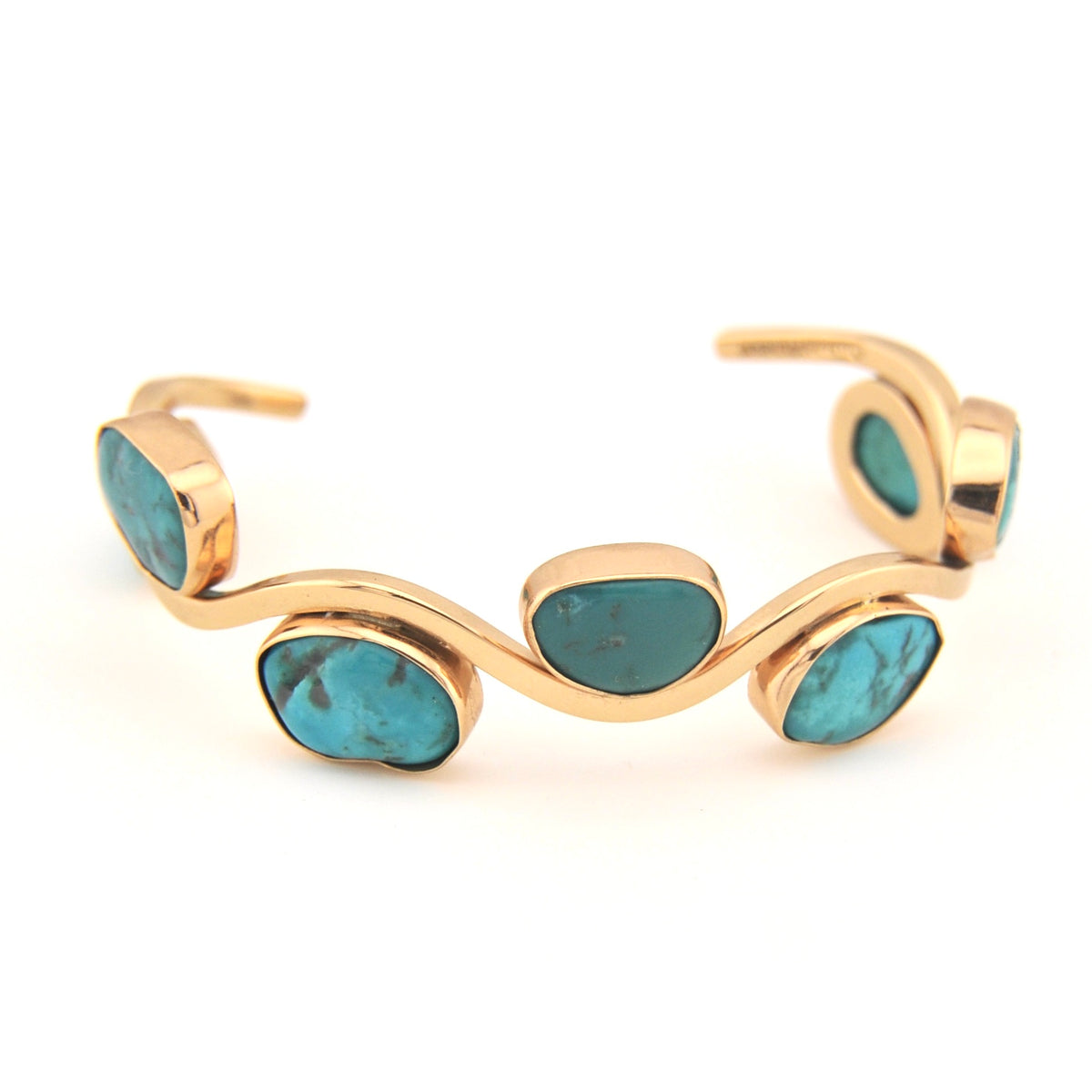 Gold bracelet with turquoise stones on a white background