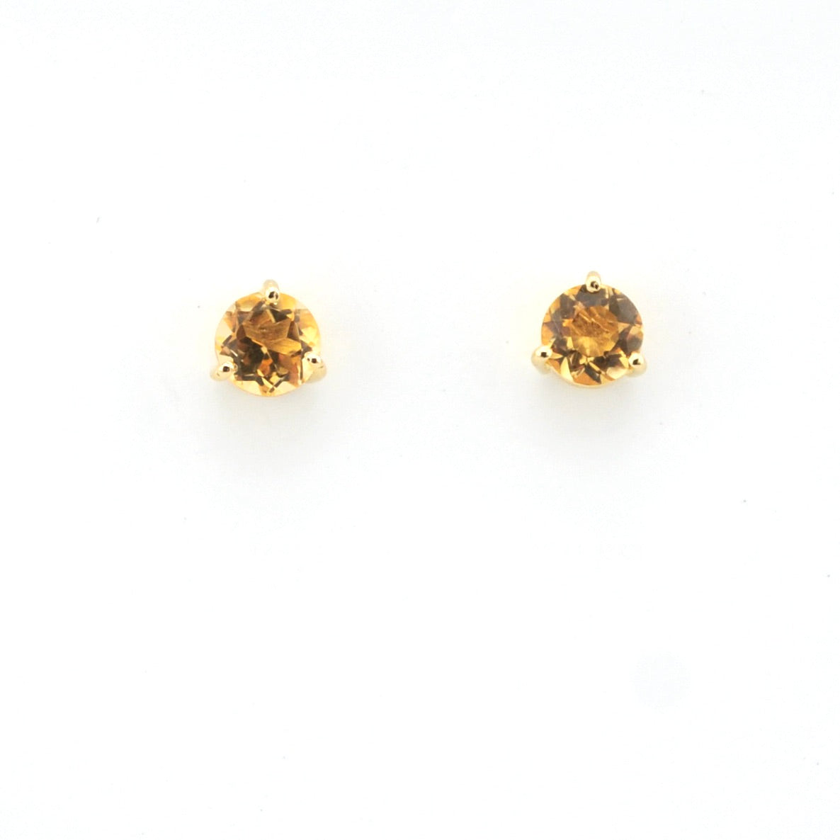 Pair of round gemstone stud earrings on a white background