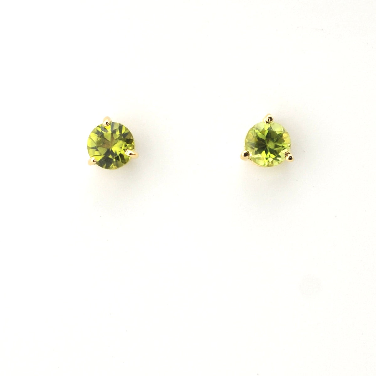 Pair of green gemstone stud earrings on a white background