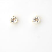 Pair of gold stud earrings with clear gemstones on a white background