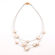 Necklace with multiple pearl-like beads on a white background