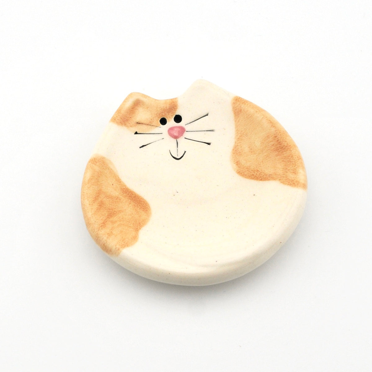 Round ceramic dish with a cat design on a white background