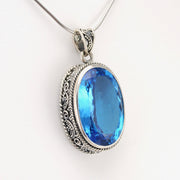 Side View Silver Blue Topaz 14x22mm Oval Bali Pendant